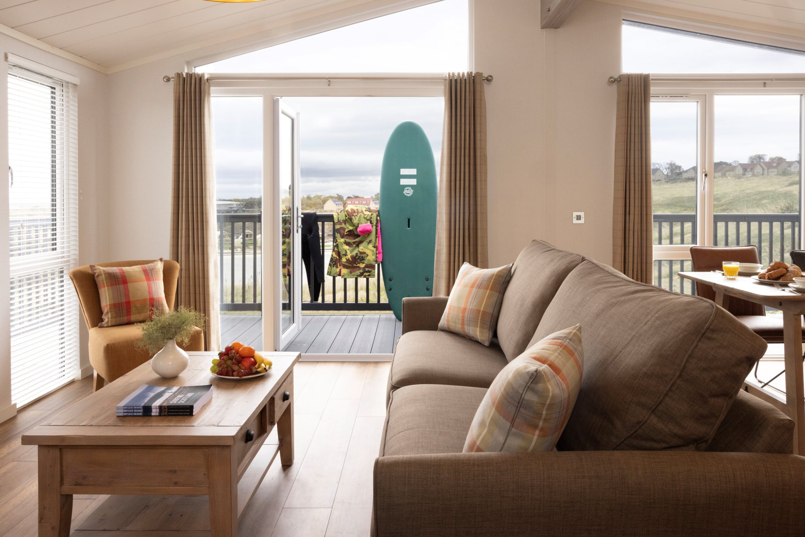 Hilltop lodge living room with surf board standing up
