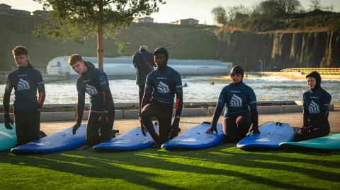 A surf class warming up for a lesson